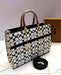 Elegant Coach Handbag – White & Black Signature Tote with Gold Accent Chain